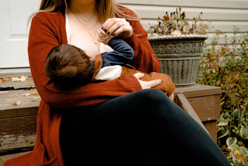 Intimate moment of a mother breastfeeding her child on a porch, symbolizing warmth and care.